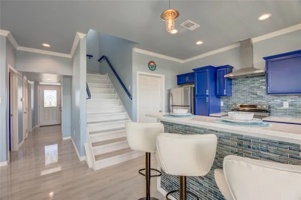 a kitchen with stainless steel appliances granite countertop a refrigerator and a stove top oven
