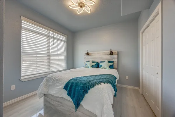 a bed sitting in a bedroom next to a window