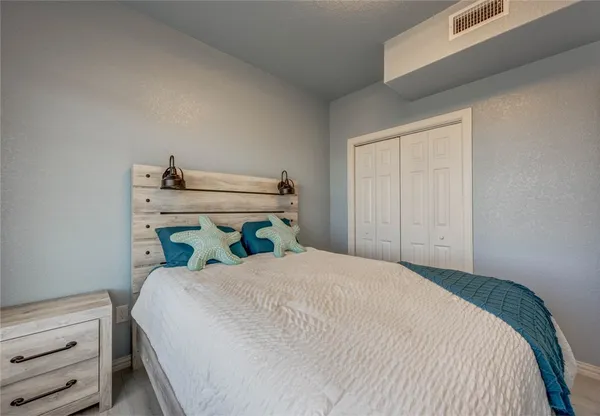 a bedroom with a bed and with cabinets