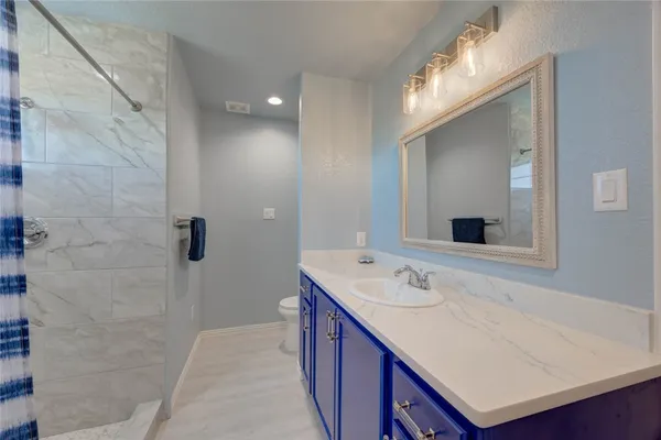 a bathroom with a sink a mirror and a shower