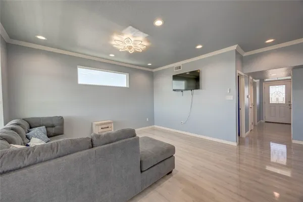a living room with furniture and a chandelier