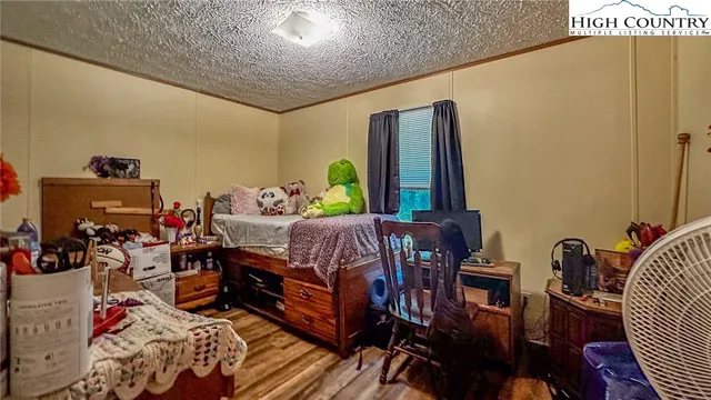 a bedroom with furniture and a window