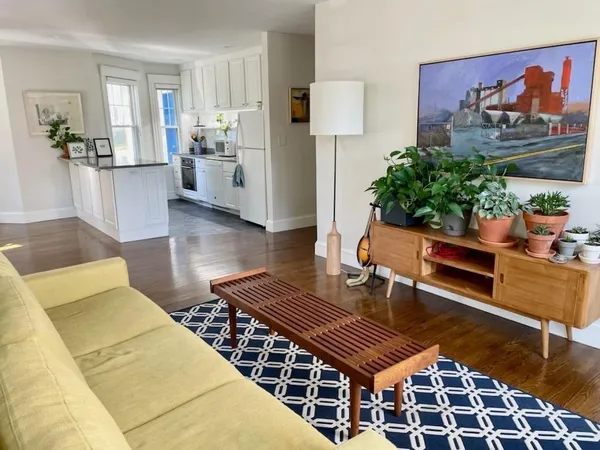 a living room with furniture and a rug