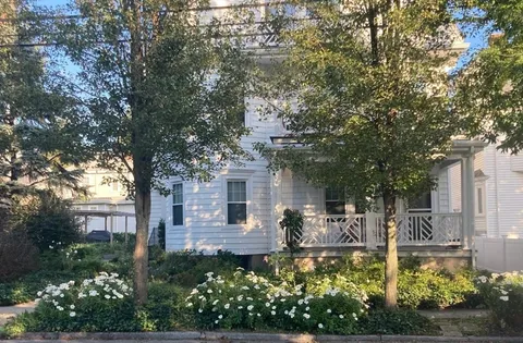 a front view of a house with garden