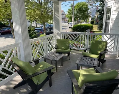a view of a patio with couches chairs and a potted plant