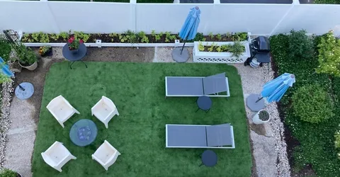 an aerial view of house with yard swimming pool and outdoor seating