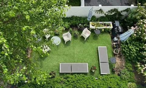 an aerial view of house with yard and outdoor seating