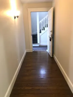 a view of a hallway view with wooden floor and staircase