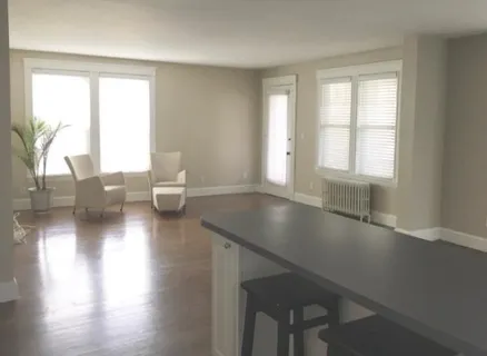 a room with wooden floor and a window