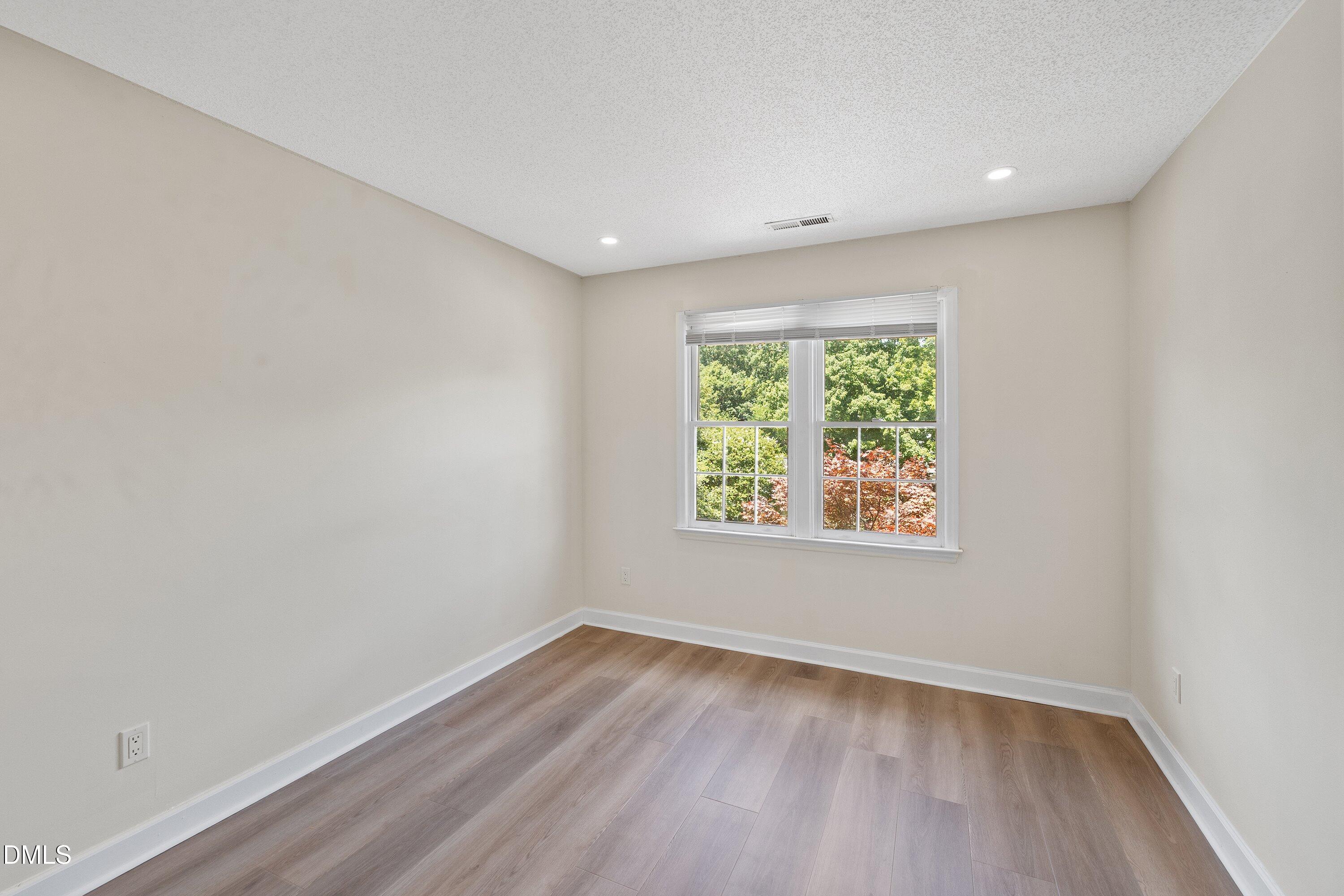 2517 Birchford Court Raleigh, NC 27604 - Photo 44 of 63 an empty room with wooden floor and window