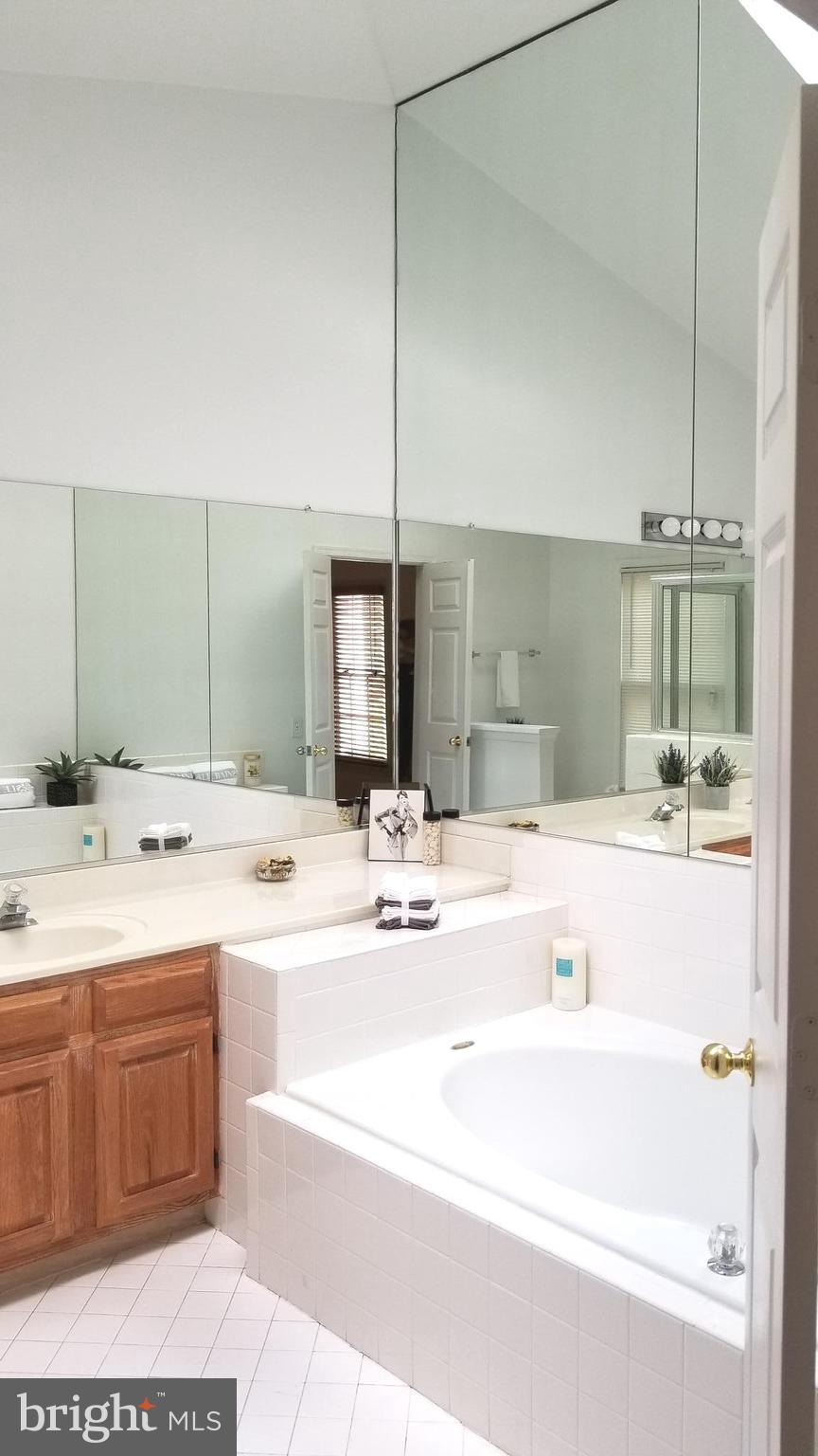 10955 Rocky Mt Way Silver Spring, MD 20902 - Photo 18 of 30 a bathroom with a tub sink and mirror