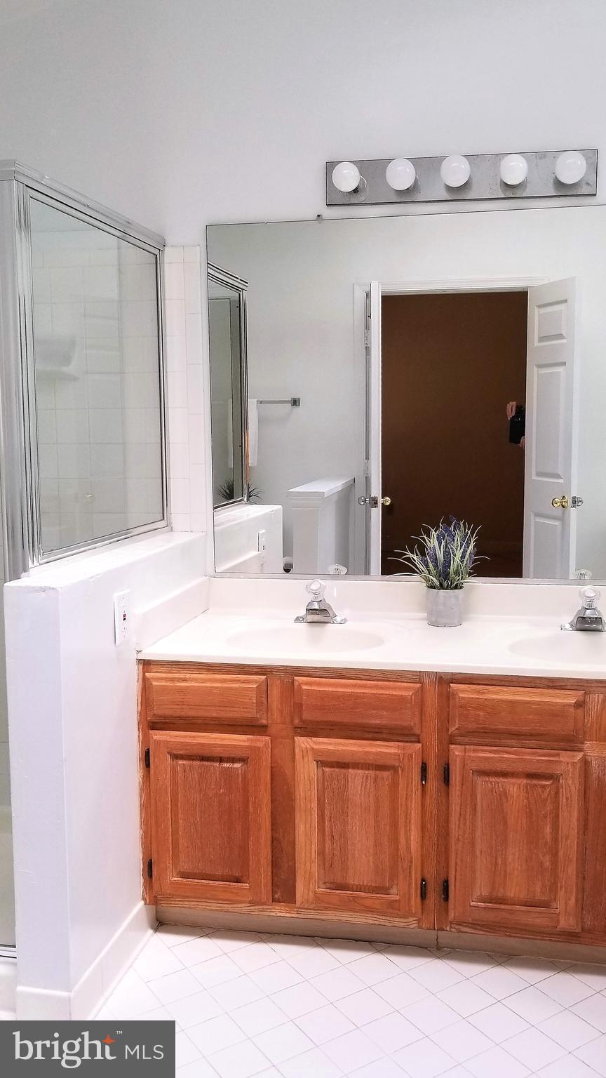 10955 Rocky Mt Way Silver Spring, MD 20902 - Photo 19 of 30 a bathroom with a sink and a mirror