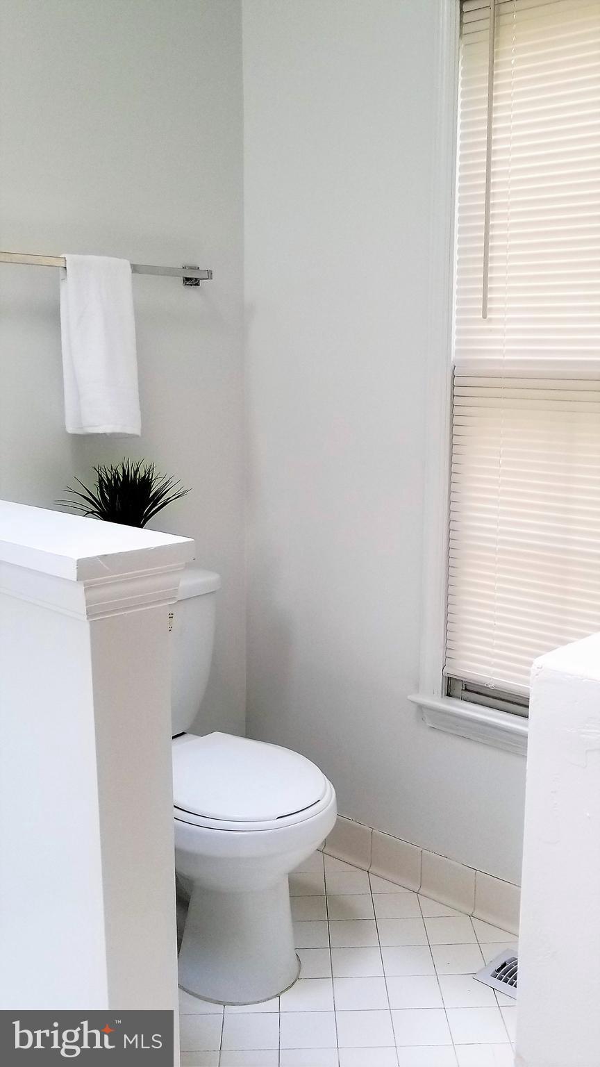10955 Rocky Mt Way Silver Spring, MD 20902 - Photo 20 of 30 a white toilet sitting next to a window