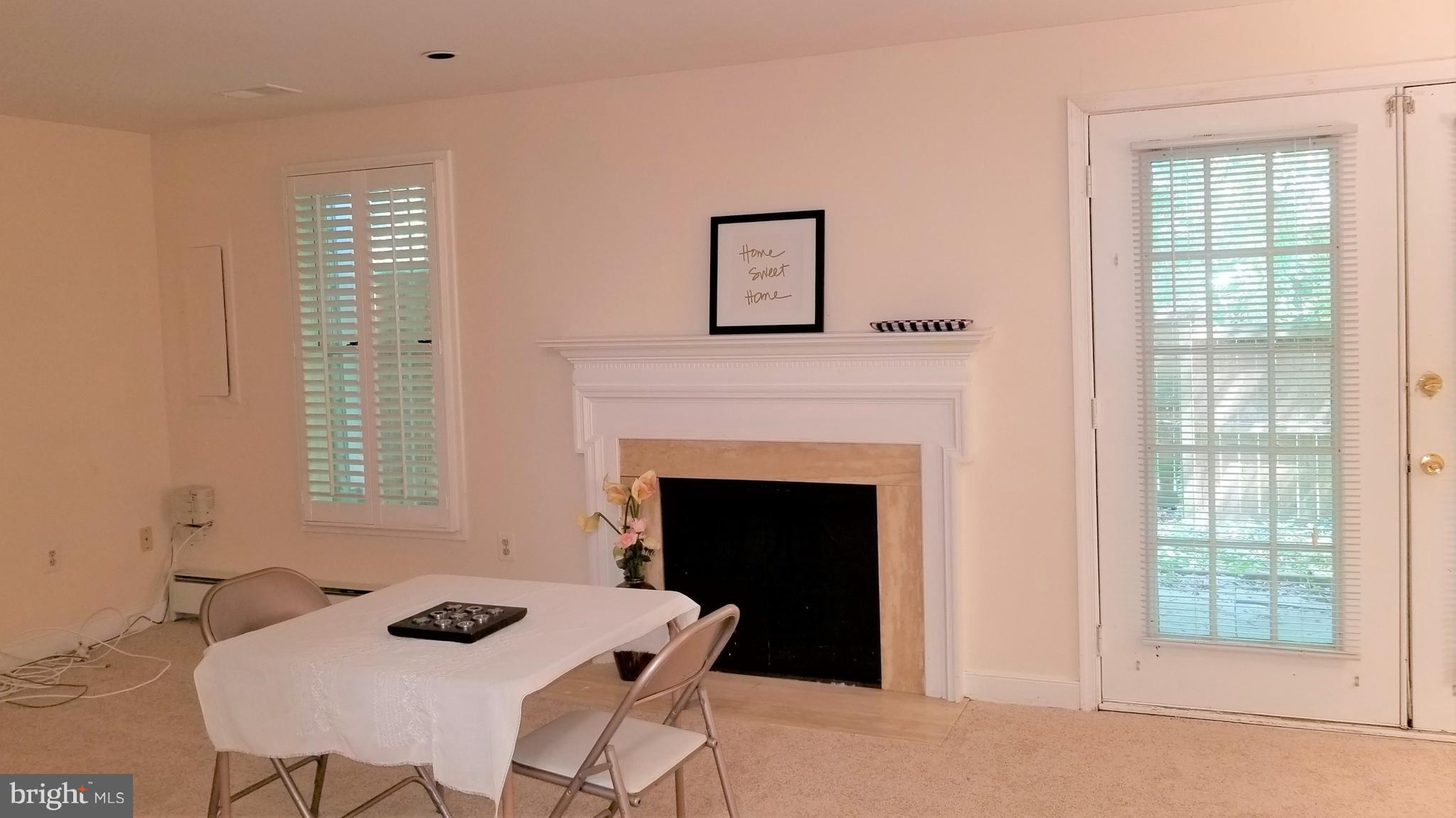 10955 Rocky Mt Way Silver Spring, MD 20902 - Photo 27 of 30 a living room with furniture and a fireplace