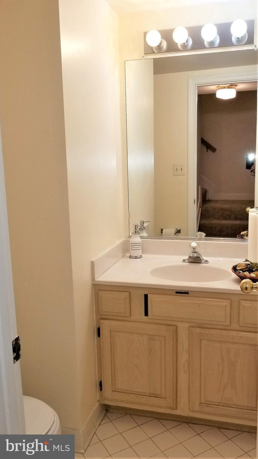 10955 Rocky Mt Way Silver Spring, MD 20902 - Photo 29 of 30 a bathroom with a sink and a mirror