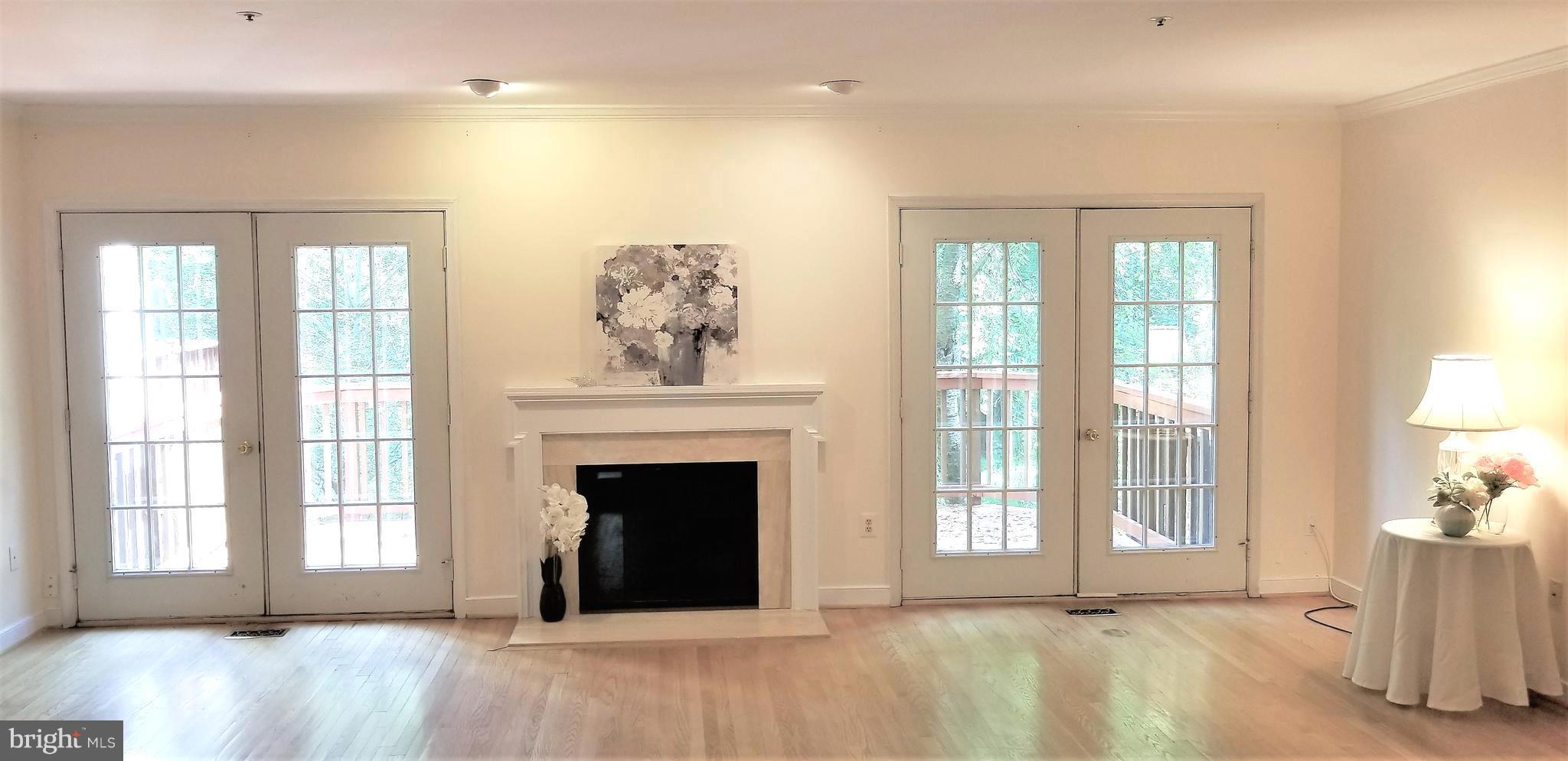 10955 Rocky Mt Way Silver Spring, MD 20902 - Photo 10 of 30 a view of an empty room with a fireplace and a window