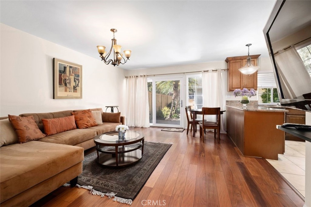 13 West Yale Loop, Unit 2 Irvine, CA 92604 - Photo 14 of 39 a living room with furniture a large window and a chandelier