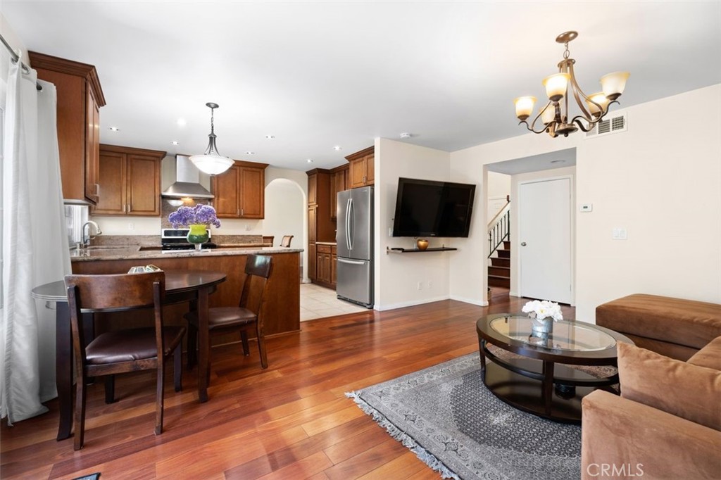 13 West Yale Loop, Unit 2 Irvine, CA 92604 - Photo 17 of 39 a living room with fireplace furniture and a flat screen tv