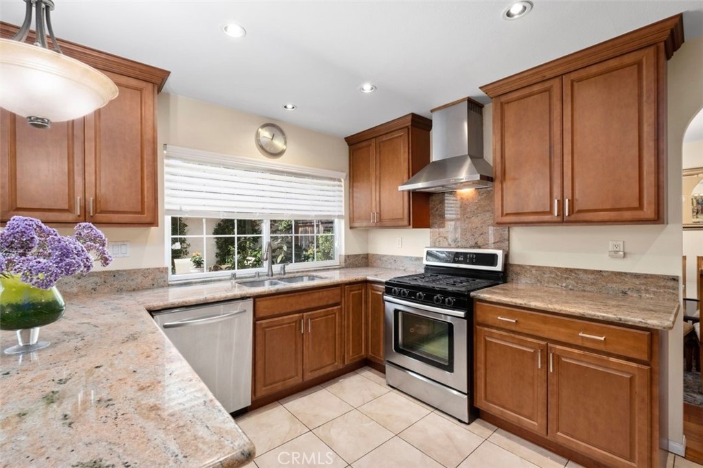 13 West Yale Loop, Unit 2 Irvine, CA 92604 - Photo 19 of 39 a kitchen with stainless steel appliances granite countertop a sink stove and cabinets