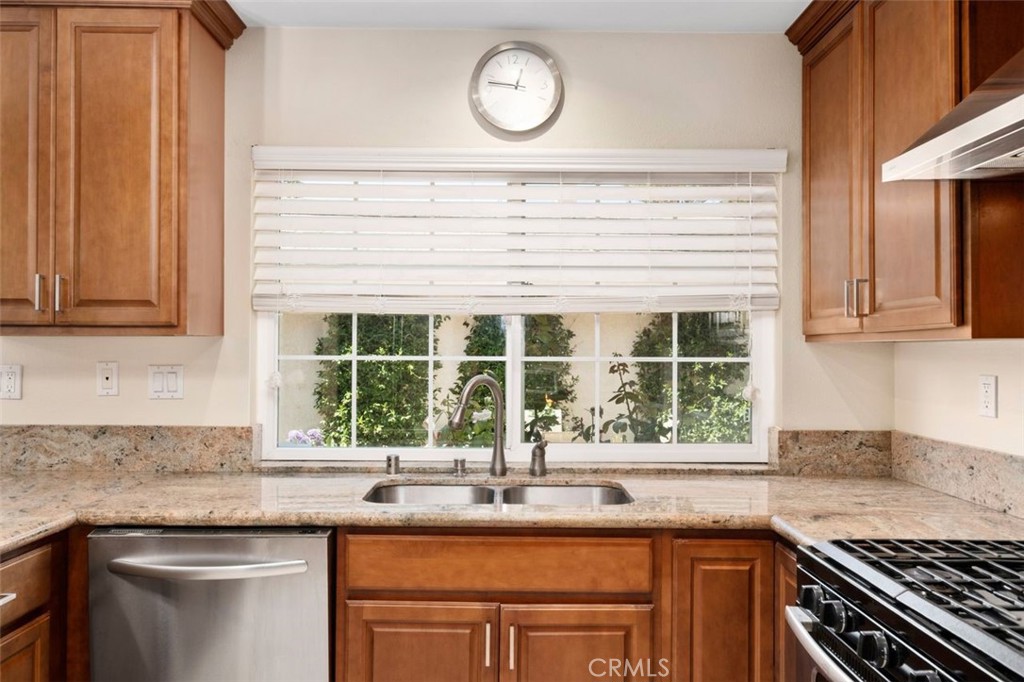 13 West Yale Loop, Unit 2 Irvine, CA 92604 - Photo 20 of 39 a kitchen with granite countertop a sink a stove and cabinets