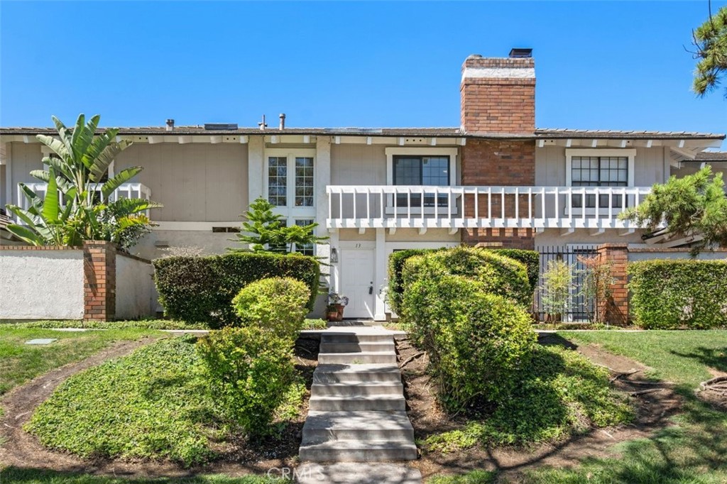 13 West Yale Loop, Unit 2 Irvine, CA 92604 - Photo 2 of 39 a front view of a house with garden