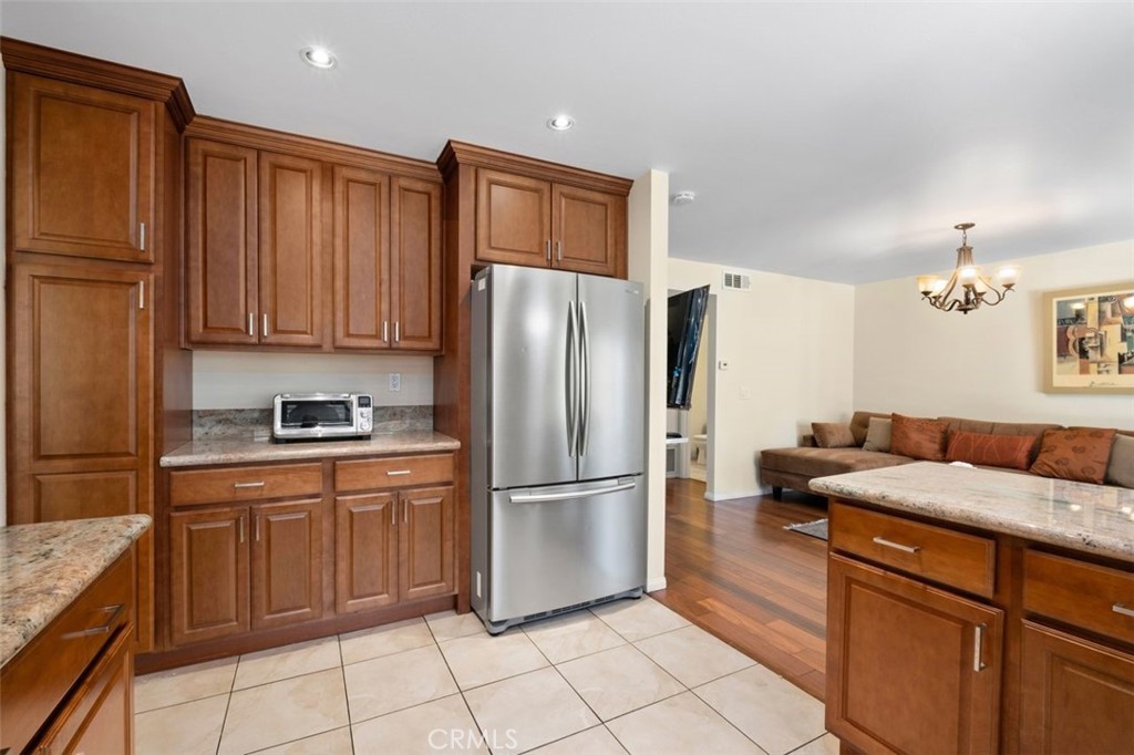 13 West Yale Loop, Unit 2 Irvine, CA 92604 - Photo 22 of 39 a kitchen with stainless steel appliances granite countertop a refrigerator sink and cabinets