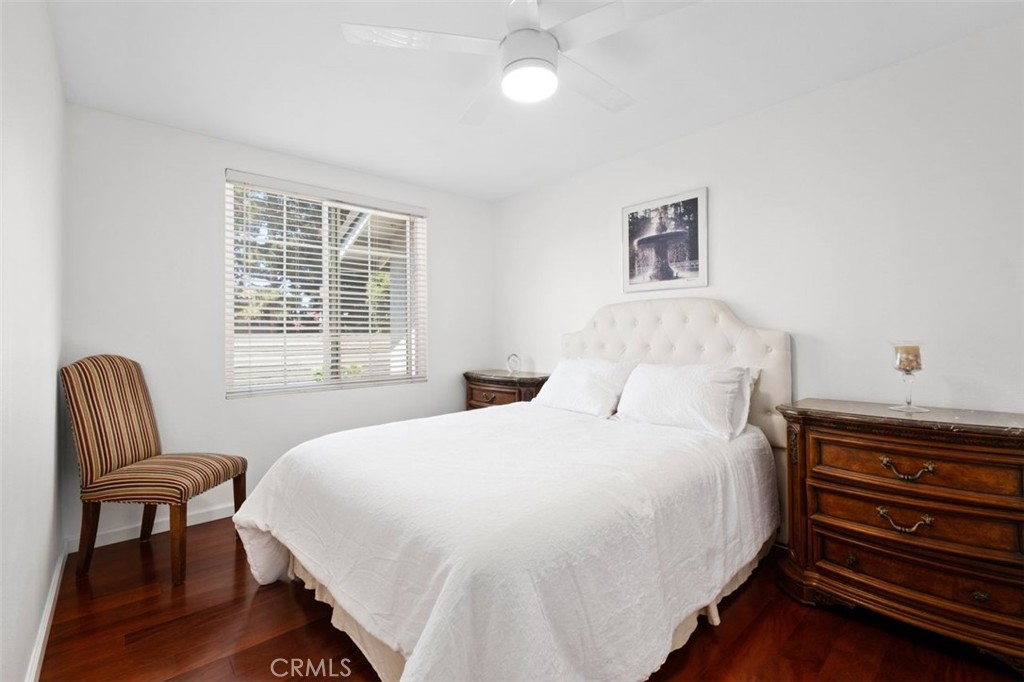 13 West Yale Loop, Unit 2 Irvine, CA 92604 - Photo 30 of 39 a bedroom with a bed and a chair