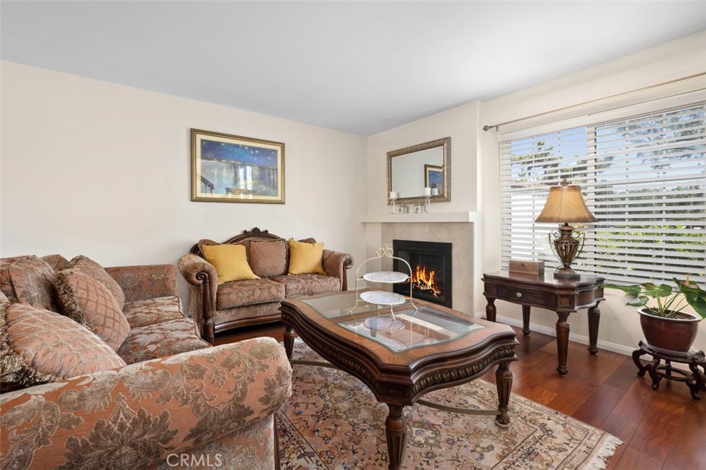 13 West Yale Loop, Unit 2 Irvine, CA 92604 - Photo 10 of 39 a living room with furniture a table and a fireplace