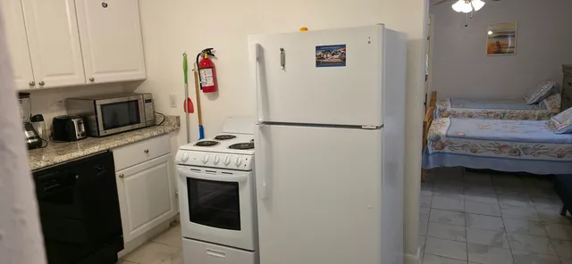 a view of a dining room and livingroom with furniture wooden floor and a chandelier