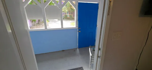 a bedroom with furniture and a mirror