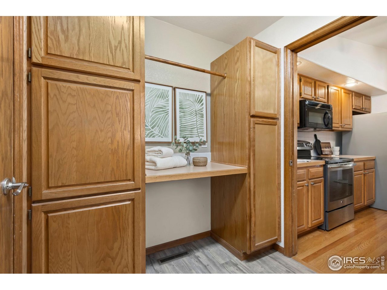 1531 West Swallow Road, Unit 28 Fort Collins, CO 80526 - Photo 11 of 23 a kitchen with kitchen island a counter top space wooden floor and stainless steel appliances