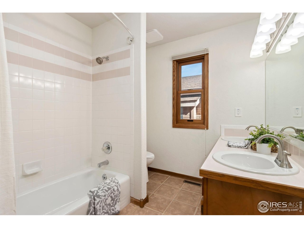 1531 West Swallow Road, Unit 28 Fort Collins, CO 80526 - Photo 15 of 23 a bathroom with a sink toilet and shower