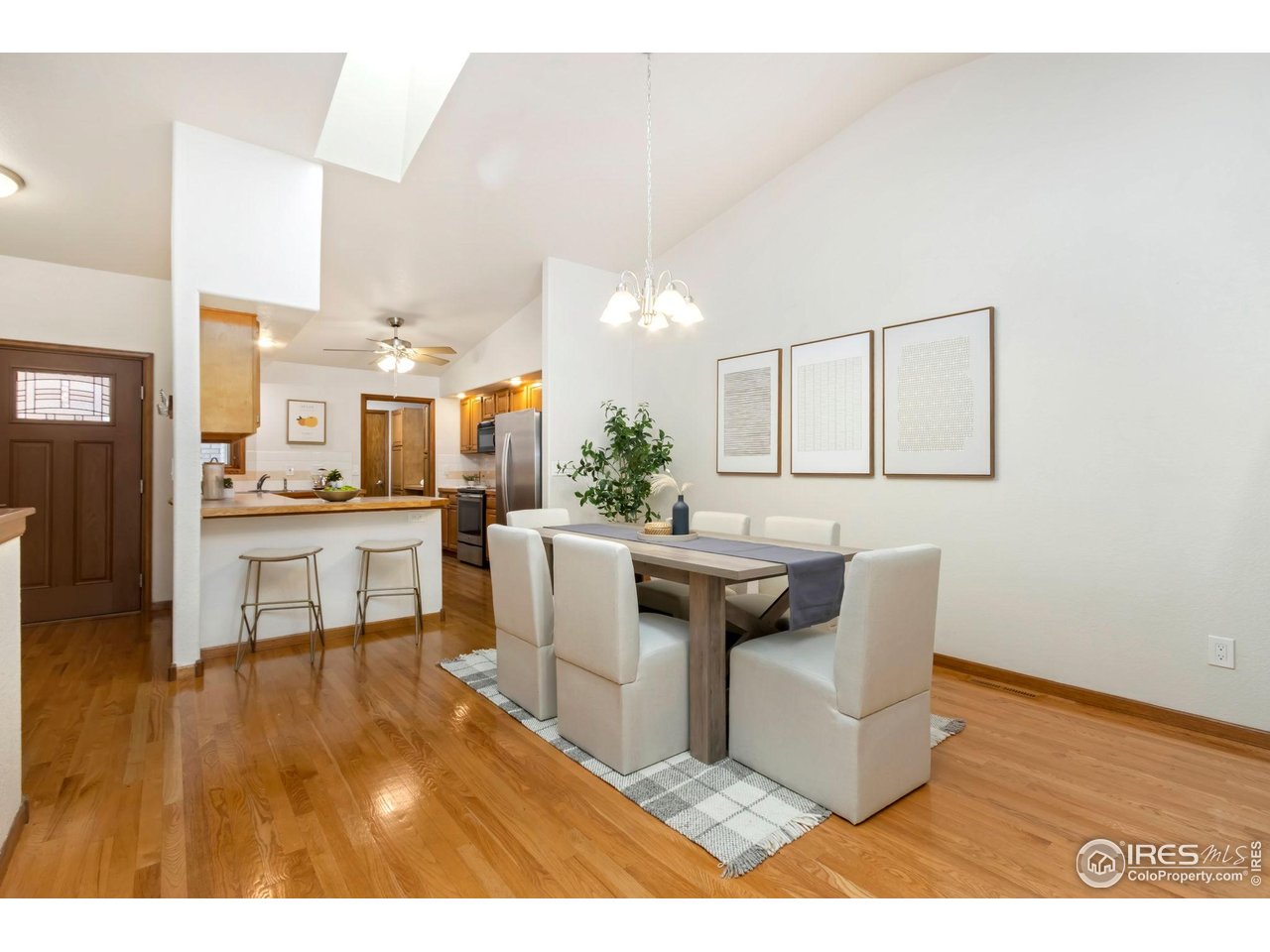 1531 West Swallow Road, Unit 28 Fort Collins, CO 80526 - Photo 5 of 23 a living room with couches and kitchen view with wooden floor