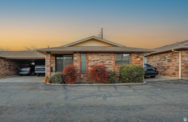 375 South Main Street, Unit 4 St. George, UT 84770 - Photo 1 of 1 Single story home featuring brick siding, an attached carport, and roof with shingles