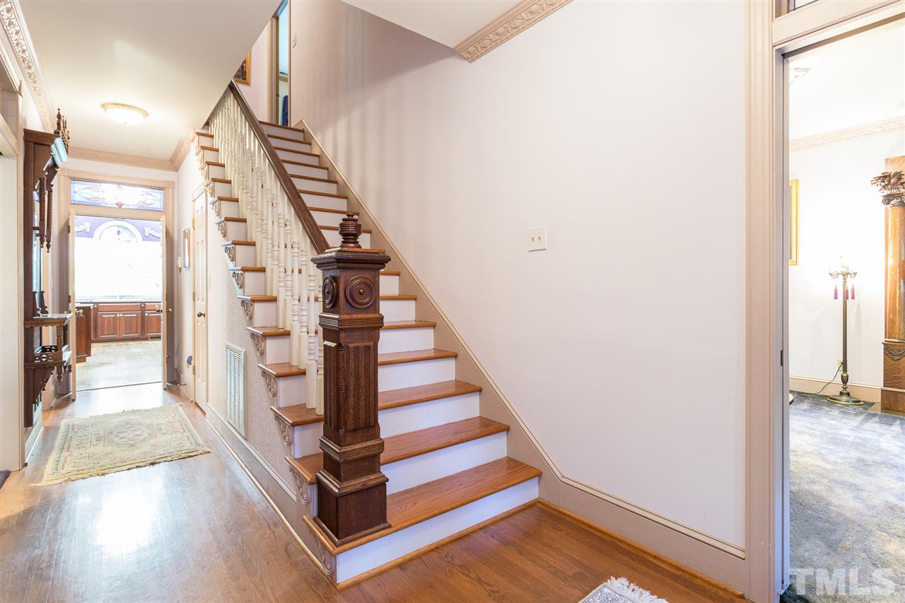 8329 Glory Road Zebulon, NC 27597 - Photo 2 of 30 When entering this beautiful foyer, you will find this beautiful wooden staircase, crown molding and stained glass transom windows.