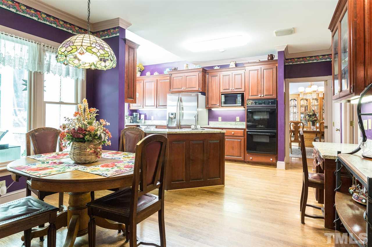 8329 Glory Road Zebulon, NC 27597 - Photo 11 of 30 This large Eat In Kitchen features all new SS appliances and granite counter-tops. Cherry Cabinets and storage for days!! Washing the dishes or cooking will not be a chore in this bright kitchen with wall of windows overlooking this beautiful yard!