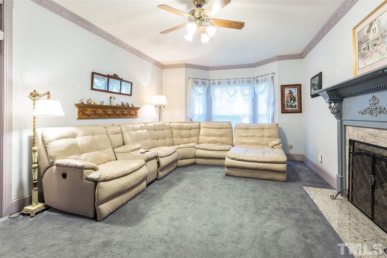 8329 Glory Road Zebulon, NC 27597 - Photo 14 of 30 This Den has brand new neutral colored carpet with a gas fireplace and bay window. Pocket Doors and Crown molding add to the charm of this room.