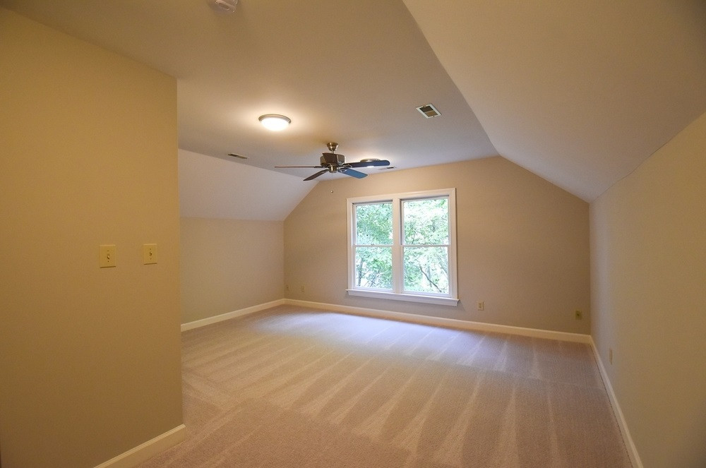 9004 Enfield Court Raleigh, NC 27615 - Photo 24 of 30 Lg 3rd floor Bedroom 4 w/neutral carpet, lg closet & CF; nearby unfinished WI Attic storage area; cement-floored WI crawl space adds more storage space. Bedroom 4