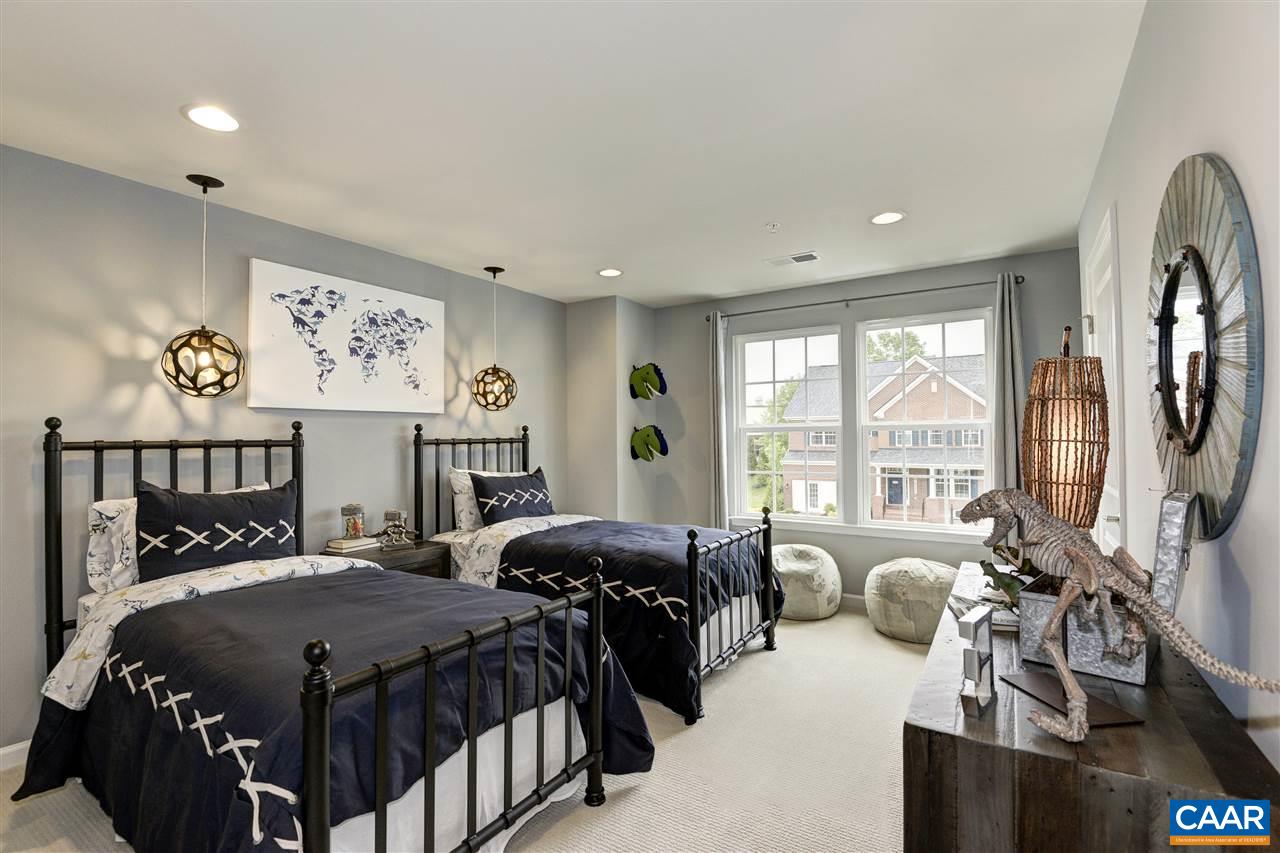 1634 Fowler Ridge Court Charlottesville, VA 22901 - Photo 12 of 28 a bedroom with a bed couch and a large window