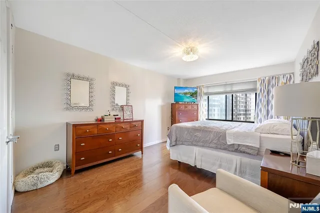 a living room with furniture and a dresser