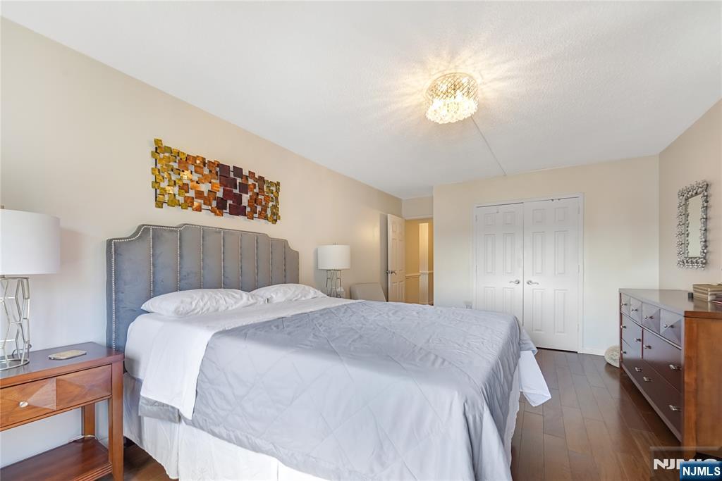 307 Prospect Avenue, Unit 9A Hackensack, NJ 07601 - Photo 15 of 29 a spacious bedroom with a bed and a chandelier