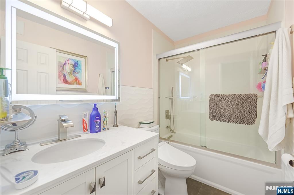 307 Prospect Avenue, Unit 9A Hackensack, NJ 07601 - Photo 16 of 29 a bathroom with a sink a toilet and shower