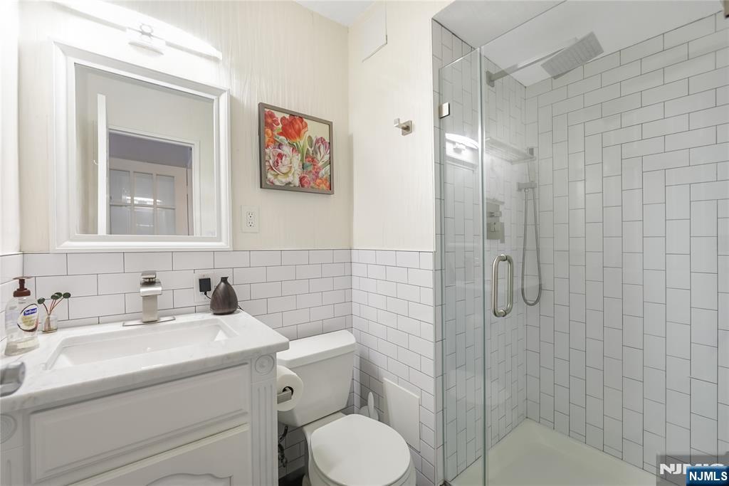 307 Prospect Avenue, Unit 9A Hackensack, NJ 07601 - Photo 18 of 29 a bathroom with a sink toilet and shower