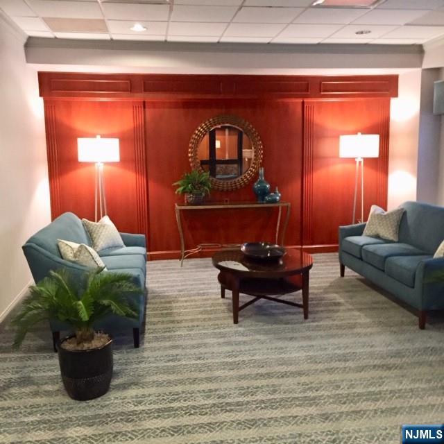 307 Prospect Avenue, Unit 9A Hackensack, NJ 07601 - Photo 2 of 29 a living room with furniture and a potted plant