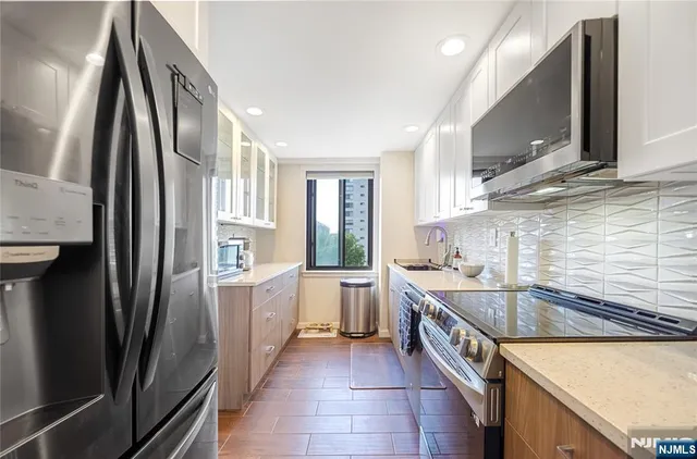 a kitchen with a sink stove and refrigerator