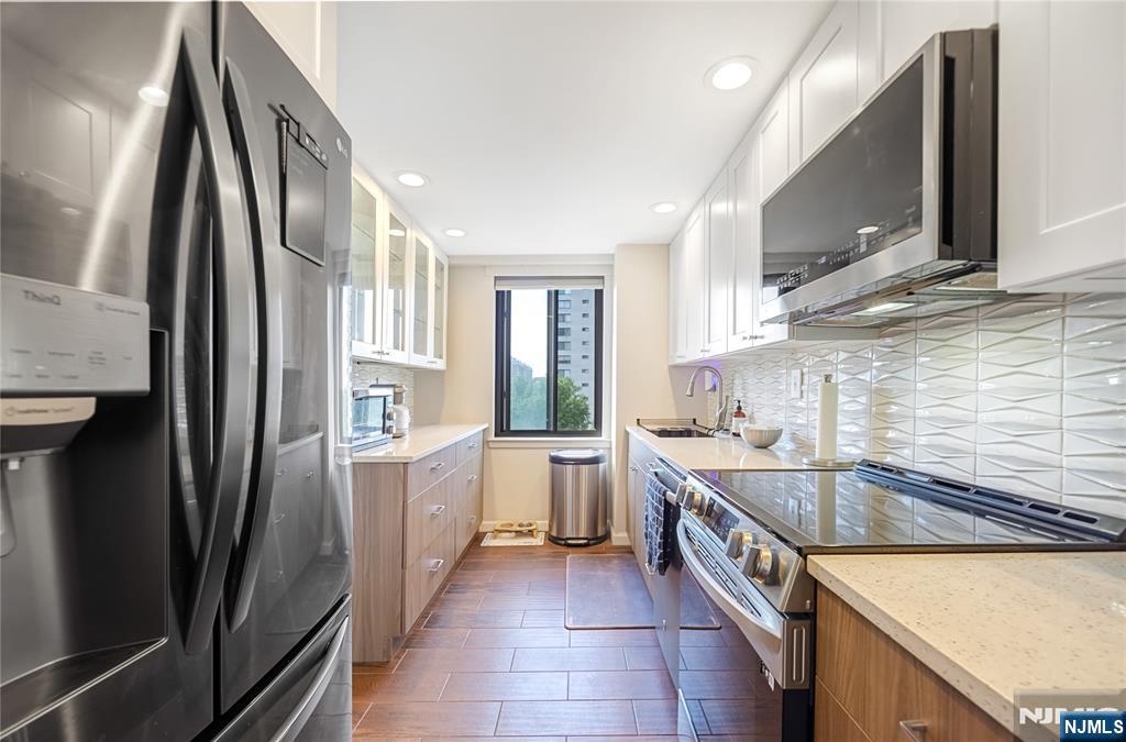 307 Prospect Avenue, Unit 9A Hackensack, NJ 07601 - Photo 23 of 29 a kitchen with a sink stove and refrigerator