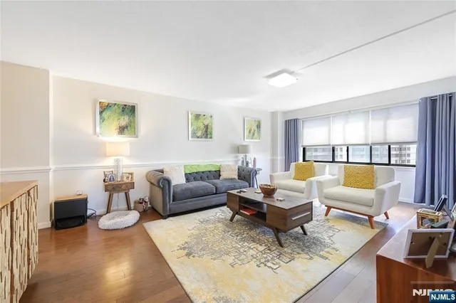 a living room with furniture or couch and a wooden floor