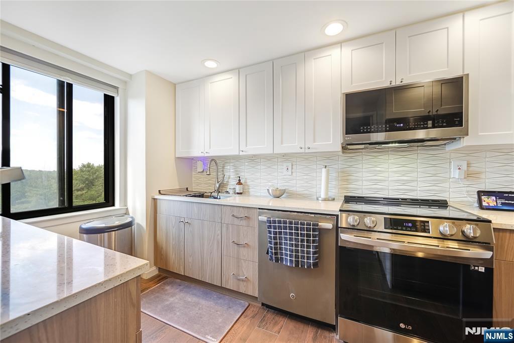 307 Prospect Avenue, Unit 9A Hackensack, NJ 07601 - Photo 10 of 29 a kitchen with a stove microwave and sink