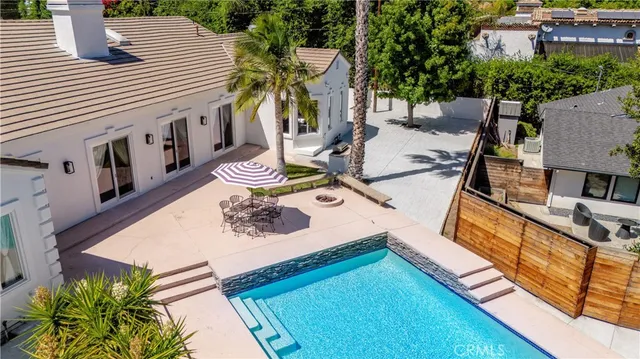 a view of a house with backyard and sitting area