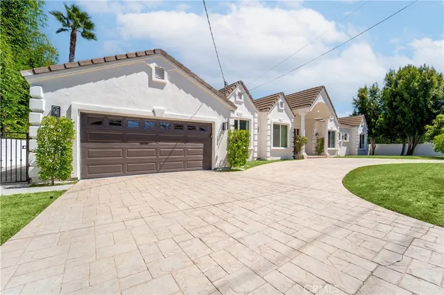 a living room with furniture kitchen view and a large window